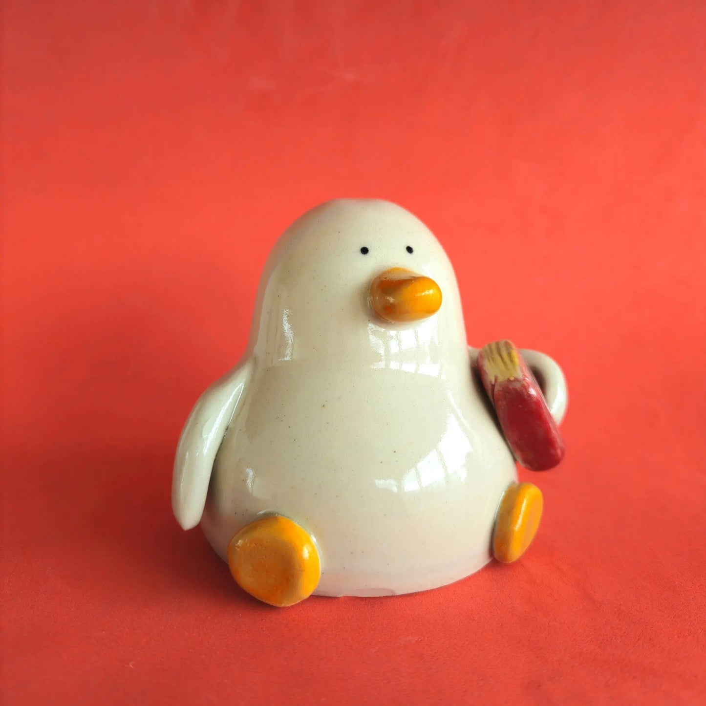 Rory with the Story - Duck with Book - Richard Moonstreet Ceramics Handmade ceramic duck holding a book under the wing. The book is called War and Geese, a play on War and Peace