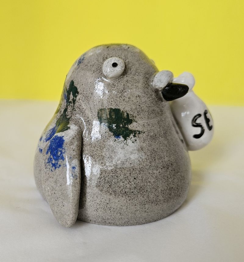 Ceramic pigeon ornament with bag of seed