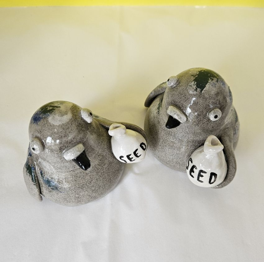Ceramic pigeon ornament with bag of seed