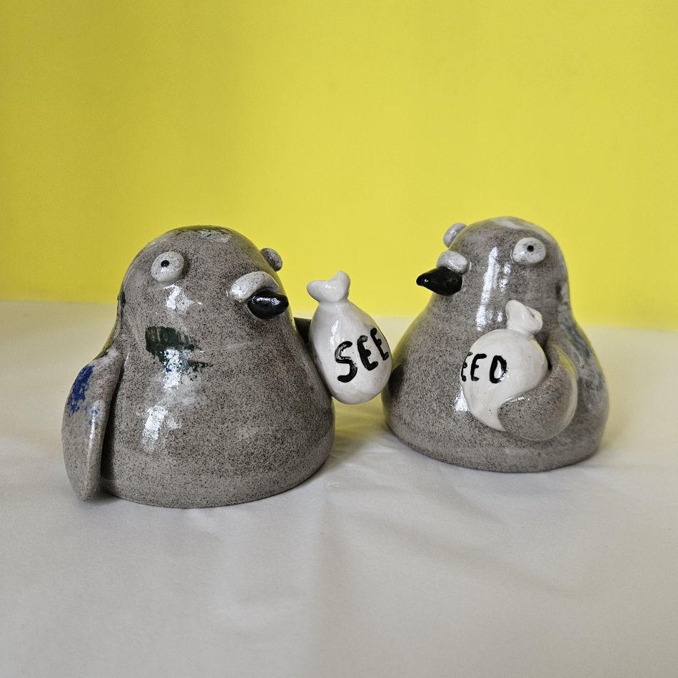 Ceramic pigeon ornament with bag of seed